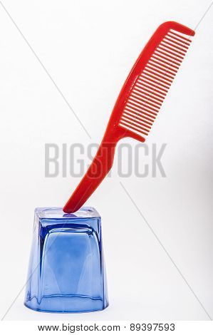 comb balanced on a glass colored