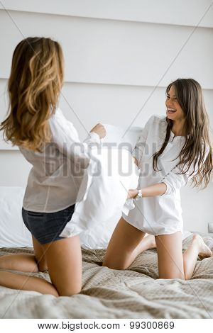 Two Beautiful Girls Fighting With Pillows