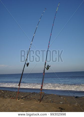 Shingle and sand beach with two fishing rods
