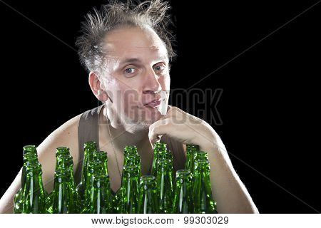 The happy tipsy man near empty beer bottles