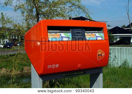 Bright orange Dutch PostNL mailbox