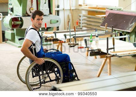 Worker In Wheelchair In A Carpenter's Workshop
