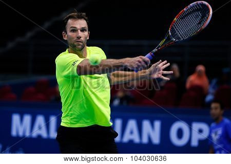 KUALA LUMPUR, MALAYSIA - SEPTEMBER 30, 2015: Ivo Karlovic of Croatia hits a backhand return in his match at the Malaysian Open 2015 Tennis tournament held at the Putra Stadium, Malaysia.