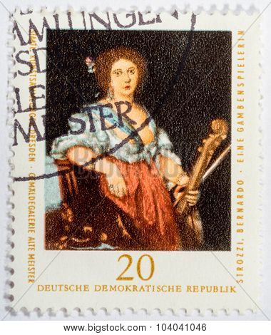 Gdr - Circa 1976: A Stamp Printed In Gdr Shows A Viol Player By Bernardo Strozzi, Circa 1976