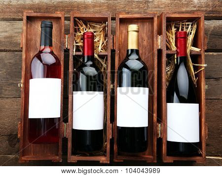 Wine bottles in wooden cases, close up.