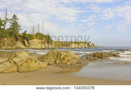 Lighthouse On A Rugged Coastal Beach