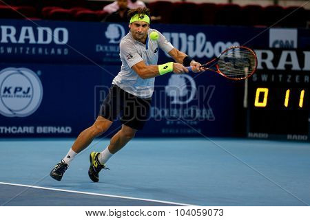 KUALA LUMPUR, MALAYSIA - OCTOBER 01, 2015: David Ferrer of Spain plays a backhand return in his match at the Malaysian Open 2015 Tennis tournament held at the Putra Stadium, Malaysia.