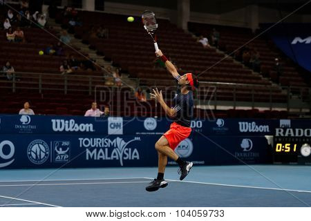 KUALA LUMPUR, MALAYSIA - OCTOBER 01, 2015: Marcos Baghdatis of Cyprus plays a smash return during his match at the Malaysian Open 2015 Tennis tournament held at the Putra Stadium, Malaysia.
