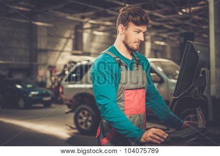 Specialist near car diagnostic pc in a workshop 