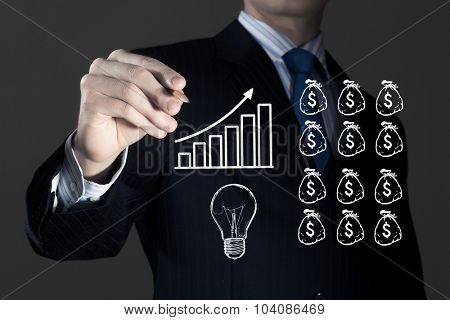 Close up of businessman drawing money making formula