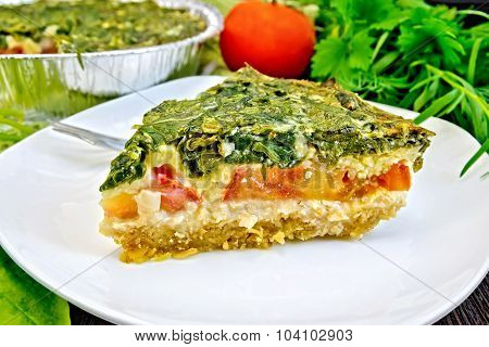 Pie celtic with spinach and tomatoes on board