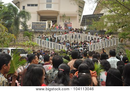 BATAM, INDONESIA - CIRCA APRIL 2015: People marched toward the church during Palm Sunday Mass at St. Joseph Church circa April 2015 in Batam Indonesia.