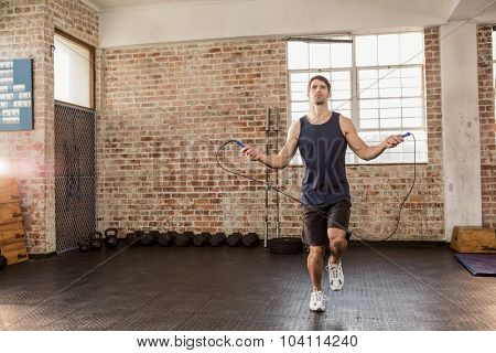 Man skipping wearing sportswear at the gym