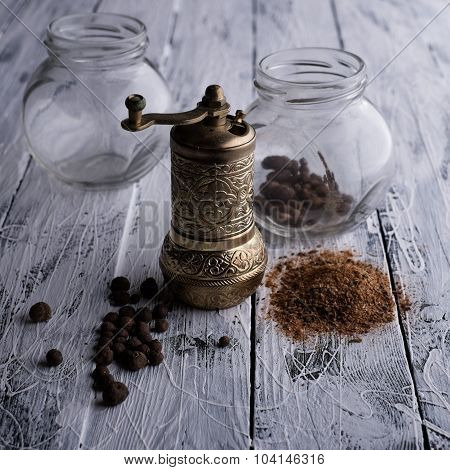 Vintage Still Life With Brass Pepper Mill Standing On The Wooden Background.