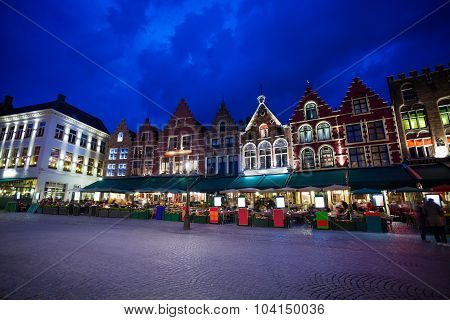 Grote Markt square with market at night in Bruges