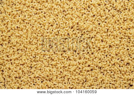dry uncooked cavatappi pasta texture background