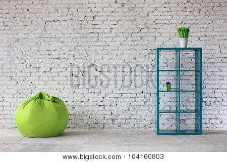 Interior in white brick with a bookshelf