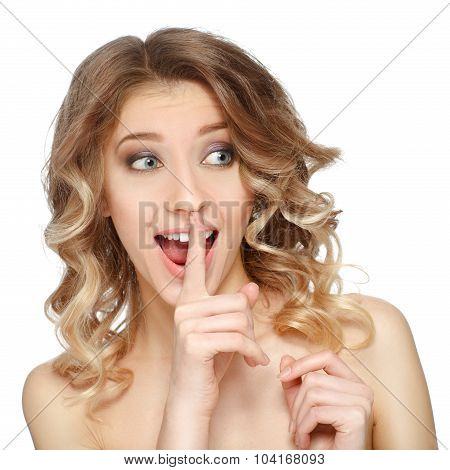 A Happy Smiling Woman Doing Silence Sign With Her Finger To Her Mouth. Isolated On White.