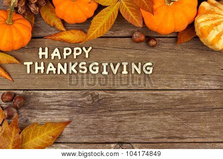 Happy Thanksgiving wooden letters with autumn corner border on wood