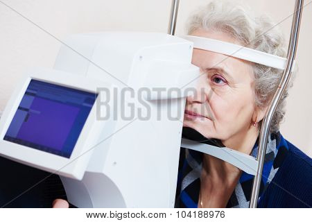 Adult optometry. Senior woman patient under eyesight examination in eye ophthalmological clinic 