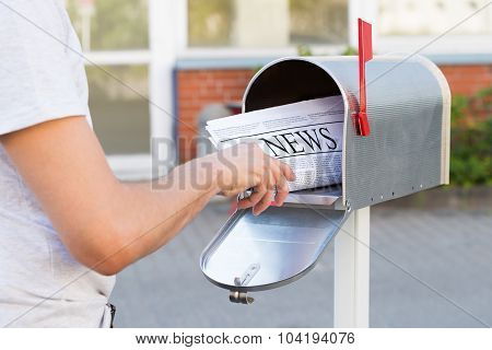 Person Hands Opening Mailbox To Remove Newspaper