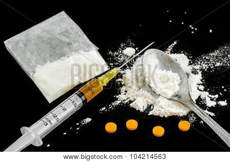 Drug Syringe, Amphetamine Tablets And Cooked Heroin.