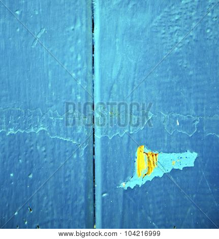 Dirty Stripped Paint In The Blue Wood Door And Rusty Nail