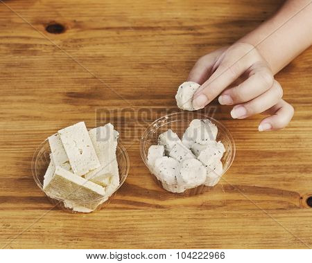 Girl Is Tasting Different Kinds Of Cheese
