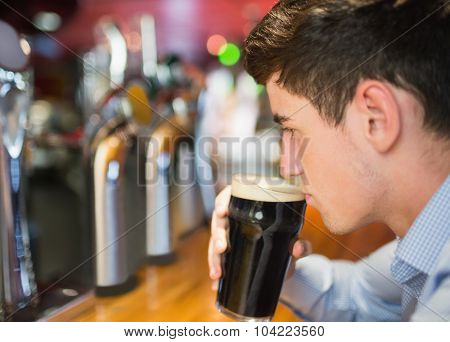 Close-up of man with drink at bar counter