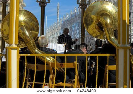 Conductor directs the orchestra on a sounding board