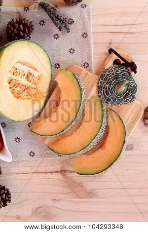 Orange Cantaloupe Melon Fruit Juicy On Wood Background.