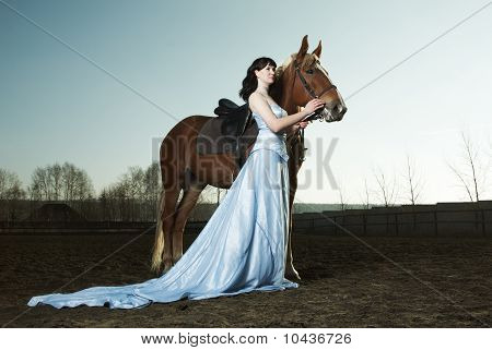 Beautiful Young Woman With A Brown Horse