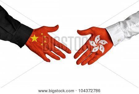 China and Hong Kong leaders shaking hands on a deal agreement