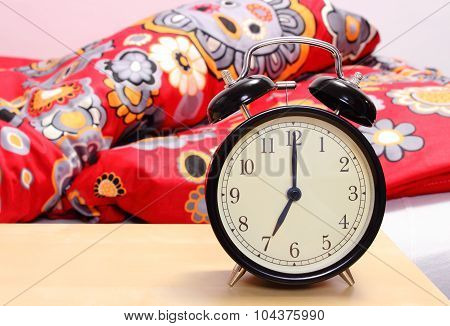 Ringing Alarm Clock And Empty Bed In Background