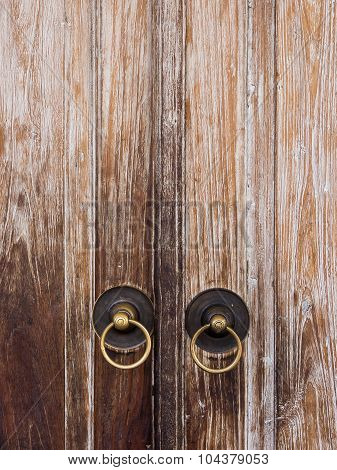 wooden door or gate and old vintage metal door ring handle knocker