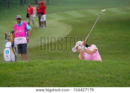 KUALA LUMPUR, MALAYSIA - OCTOBER 10, 2015: South Korea's So Yeon Ryu plays out of the sand trap of the 18th hole of the KL Golf & Country Club during the 2015 Sime Darby LPGA Malaysia golf tournament.
