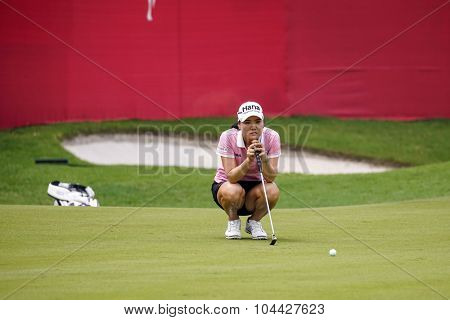 KUALA LUMPUR, MALAYSIA - OCTOBER 10, 2015: South Korea's So Yeon Ryu checks the green of the 18th hole of the KL Golf & Country Club during the 2015 Sime Darby LPGA Malaysia golf tournament.