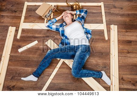 Happy Woman Having Fun Assembling Furniture.
