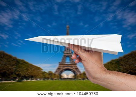 Hand trowing a paper plane in Paris