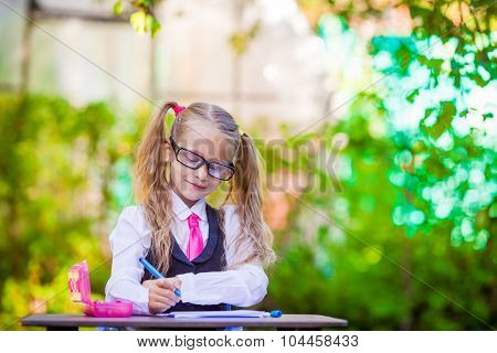 Adorable little school girl outdoor. Back to school.