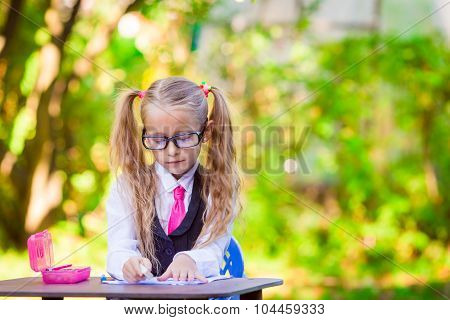 Adorable little school girl outdoor. Back to school.
