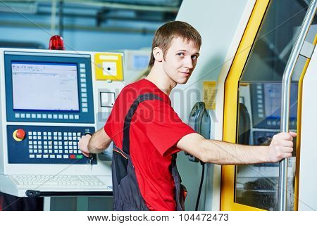 mechanical industrial worker at cnc milling machine center in tool manufacture workshop