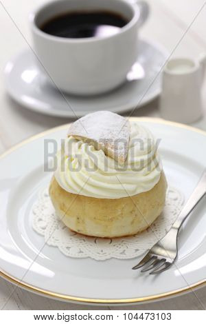 homemade semla, swedish sweet roll and cup of coffee