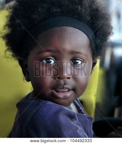 Accra, Ghana - July 1, 2014.  Unidentified Ghanaian Little Girl With Big Eyes. People Of Ghana Suffe