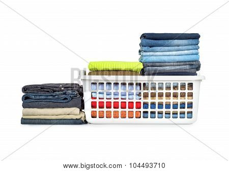 Laundry Basket With Folded Clothes Over White Background