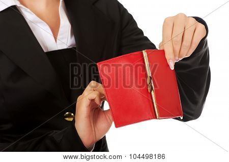 Young woman shows her empty wallet. Bankruptcy concept.