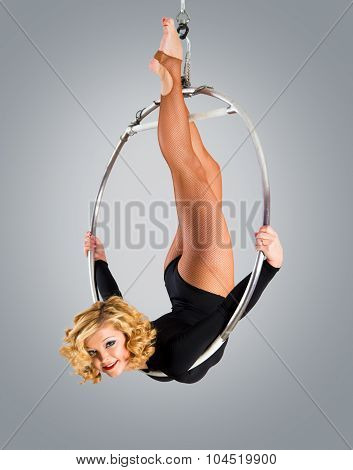 Plastic Beautiful Girl Gymnast On Acrobatic Circus Ring In Flesh-colored Suit. Aerial Ring.