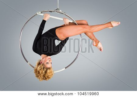 Plastic Beautiful Girl Gymnast On Acrobatic Circus Ring In Flesh-colored Suit. Aerial Ring.