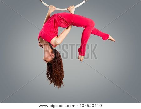 Plastic Beautiful Girl Gymnast On Acrobatic Circus Ring In Flesh-colored Suit. Aerial Ring.