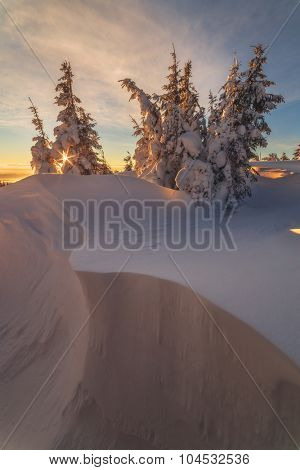Fantastic orange evening landscape glowing by sunlight. Dramatic wintry scene with snowy trees. Kukul ridge, Carpathians, Ukraine, Europe. Merry Christmas!